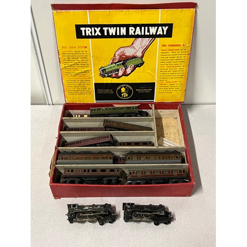 128 - Trix Twin Railway carriages and two engines in original box.