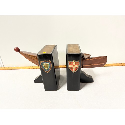 130 - Pair of vintage rowboat book ends showing the crests of Cambridge University and Downing college.