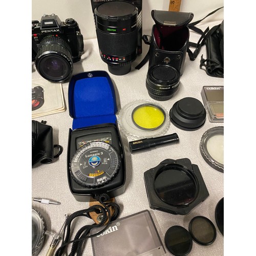 23 - Qty of photography equipment to include Pentax camera, selection of lenses, Lunasix light meter and ... 