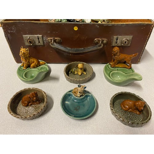 31 - Qty of wade ornaments to include dog basket pipe rests and trinket dishes etc. in vintage case.