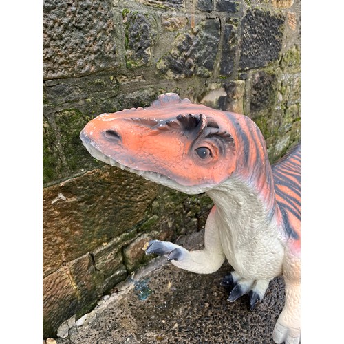 64 - Dinosaur model made from poly-resin and fibreglass orange and black stripe. Size approx. 208cm x 106... 