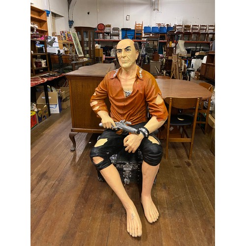 150 - Life size fibre-glass treasure island themed pirate sitting on treasure chest holding pistol. Approx... 