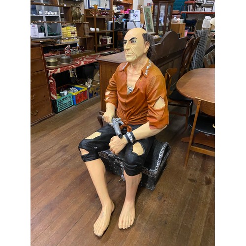 150 - Life size fibre-glass treasure island themed pirate sitting on treasure chest holding pistol. Approx... 