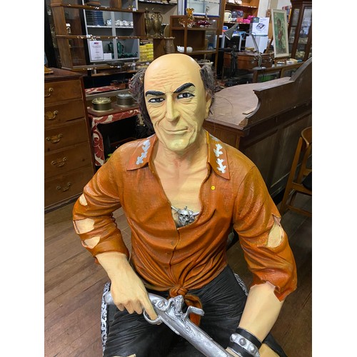 150 - Life size fibre-glass treasure island themed pirate sitting on treasure chest holding pistol. Approx... 