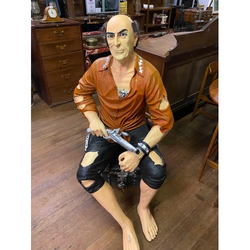 150 - Life size fibre-glass treasure island themed pirate sitting on treasure chest holding pistol. Approx... 