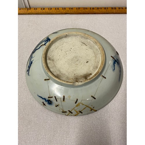 311 - 2 Antique bowls - one with floral pattern and one with dragon pattern. Both bowls have staple repair... 