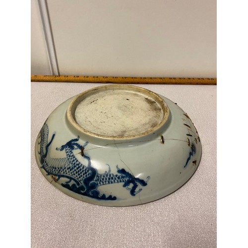 311 - 2 Antique bowls - one with floral pattern and one with dragon pattern. Both bowls have staple repair... 