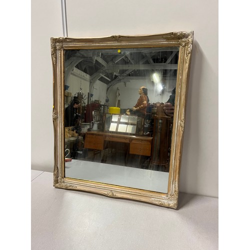 371 - Painted ornate gilt framed wall mirror. 57cm x 67cm