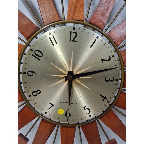 51 - Newgate teak sunburst wall clock, working.
68cm