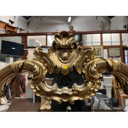 213 - Large ornate gilt framed wall mirror. h 114cm x l 136cm