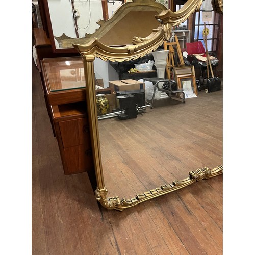 213 - Large ornate gilt framed wall mirror. h 114cm x l 136cm