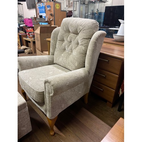 218 - Upholstered wing back arm chair with matching storage stool.