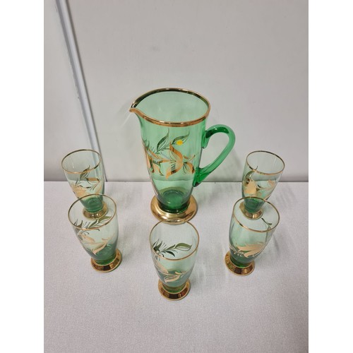 226 - Retro green glass jug along with 5 matching glasses.