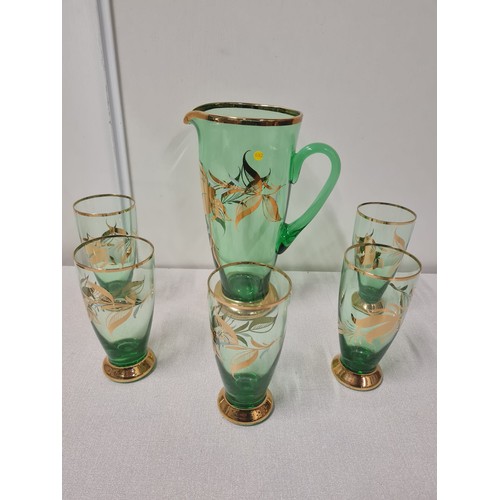 226 - Retro green glass jug along with 5 matching glasses.