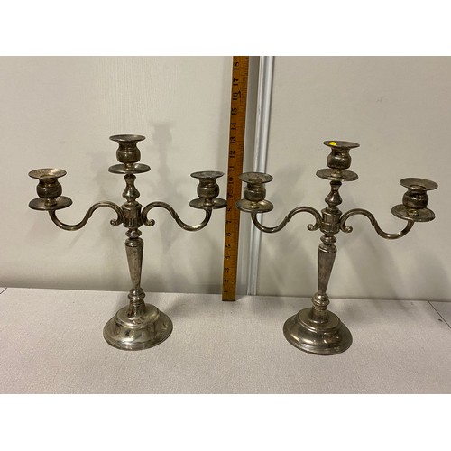 284 - Pair of plated candelabras.