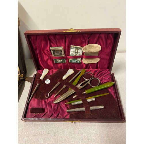 303 - Vintage cased vanity set along with sewing kit.