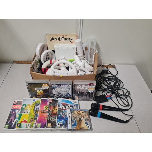 383 - Wii console and accessories with Singstar mics and games.