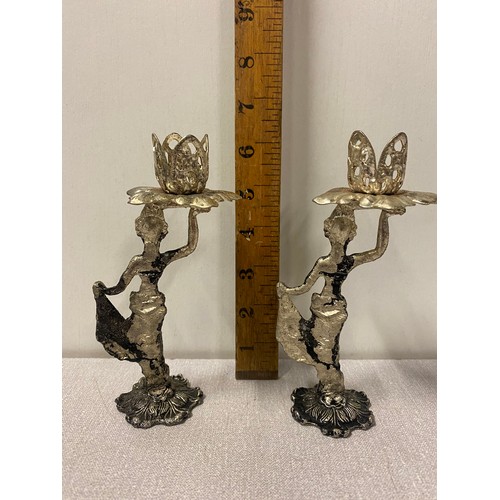 576 - Pair of small metal figurine candle sticks.