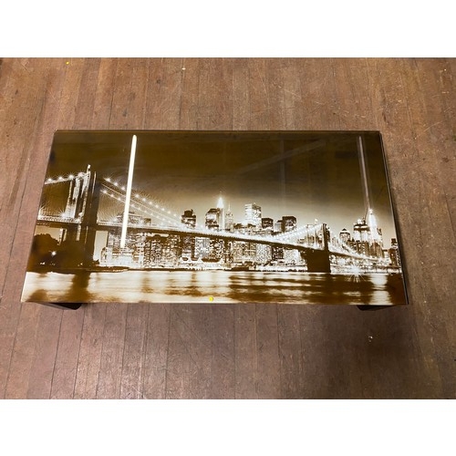 217 - Glass top coffee table depicting New York skyline.