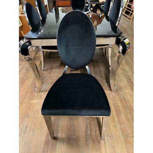 251 - Large black marble and chrome dining table with 6 matching chairs upholstered in black velvet.