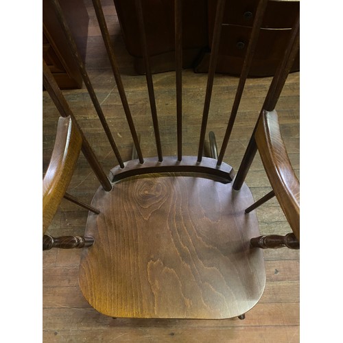 100 - Solid oak spindle back rocking chair.