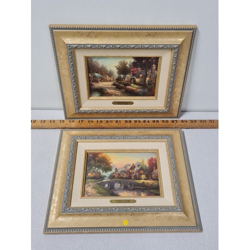 43 - Pair of framed Thomas Kinkade litho canvas prints 