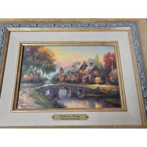 43 - Pair of framed Thomas Kinkade litho canvas prints 