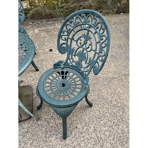 227 - Heavy cast iron 4 piece garden set - Table and 3 chairs. Comes with parasol holder.