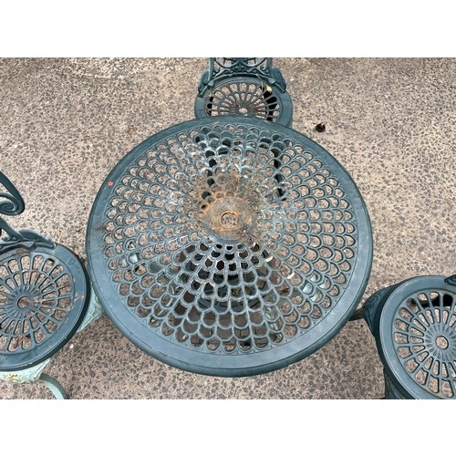 227 - Heavy cast iron 4 piece garden set - Table and 3 chairs. Comes with parasol holder.