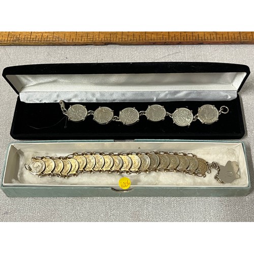 124 - 2 coin bracelets.