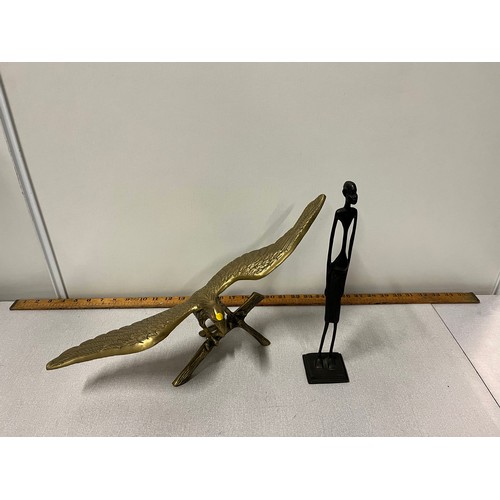 69 - Vintage brass eagle ornament along with bronze stick man  tribal ornament.
eagle 47cm l