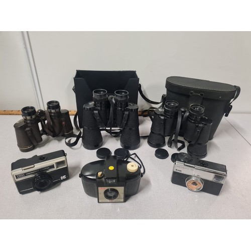 104 - 3 x vintage Kodak cameras and 3 pairs of binoculars with cases to include Regent etc.