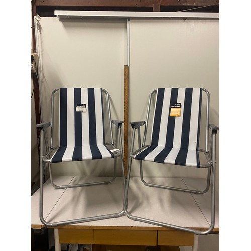 304 - 2 new folding beach chairs.