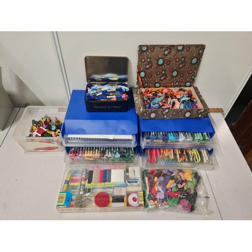 318 - Large qty of cross stitching thread etc. in storage trays.