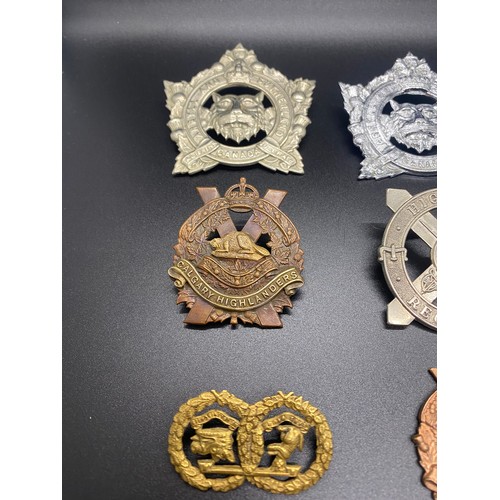 53 - Collection of 11 military cap badges to include Calgary Highlanders and Argyle and Sutherland.