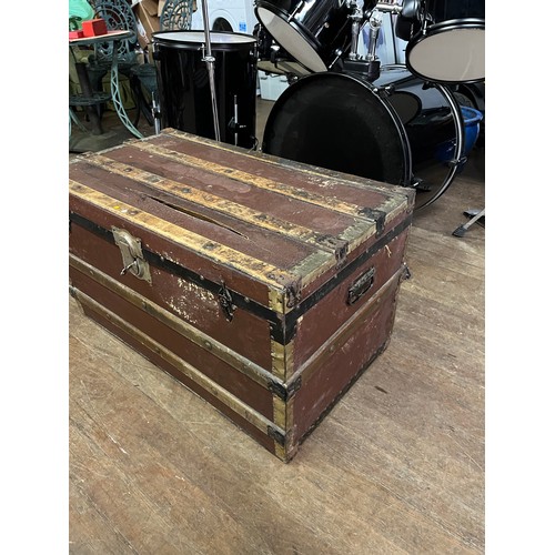 85 - Large antique wood banded travel trunk with key.
83cm long x 47cm high x 47cm deep.