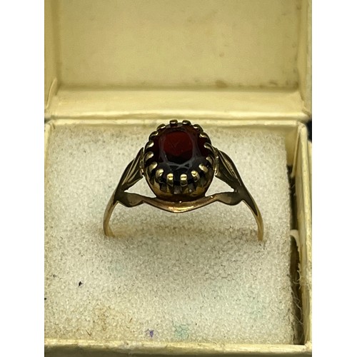 13 - 9ct gold and garnet ring.