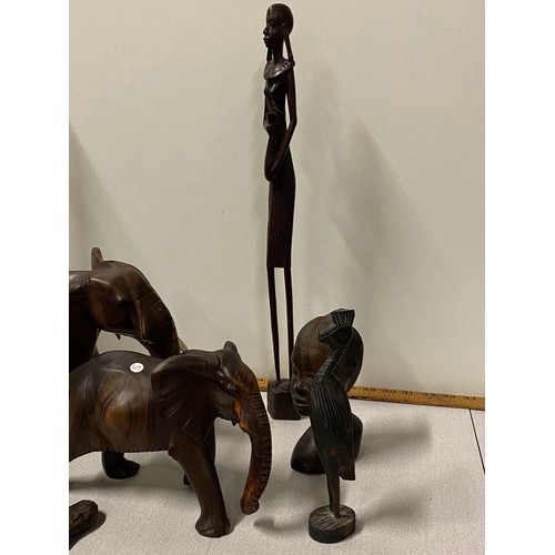 22 - Collection of carved African wooden items to include elephants, busts and letter openers etc.
Talles... 