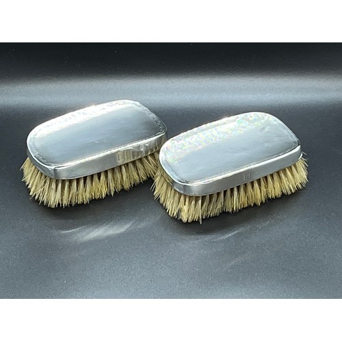 162 - Pair of hallmarked silver clothes brushes.