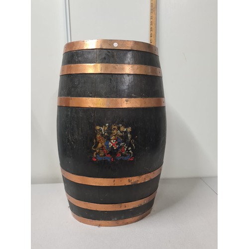 39 - 19th century brass bound oval oak barrel stick stand decorated with coat of arms.
82cm h