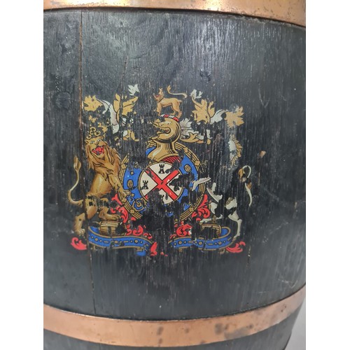 39 - 19th century brass bound oval oak barrel stick stand decorated with coat of arms.
82cm h