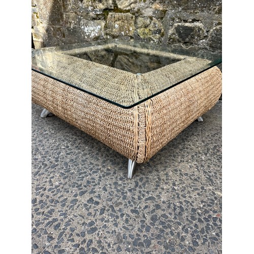 320 - Wicker glass topped coffee table on chrome feet.