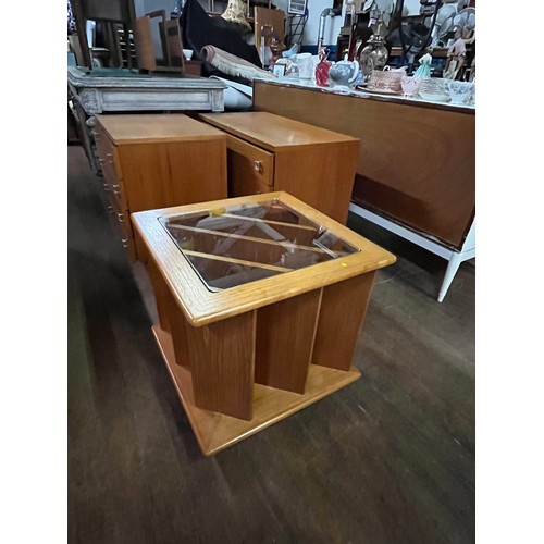 61 - Teak vinyl/magazine storage glass topped coffee table on casters.