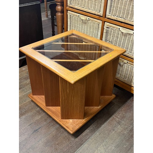 61 - Teak vinyl/magazine storage glass topped coffee table on casters.