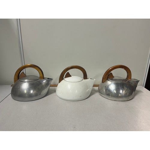 254 - 3 Piquot ware stove kettles.