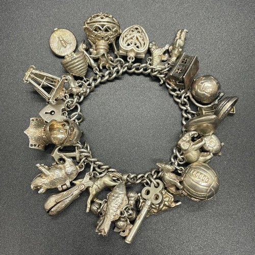 43 - Silver charm bracelet with 23 charms
112g