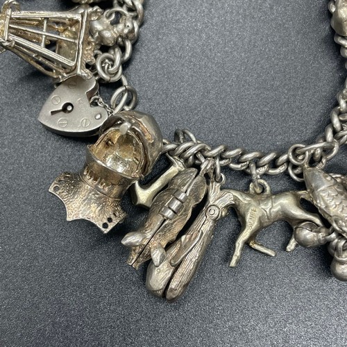 43 - Silver charm bracelet with 23 charms
112g