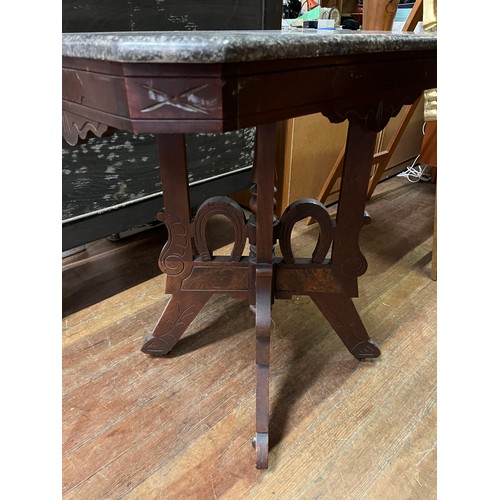 105 - antique marble top hall table with horse shoe design on metal casters
73cm l x 48cm x 75cm h