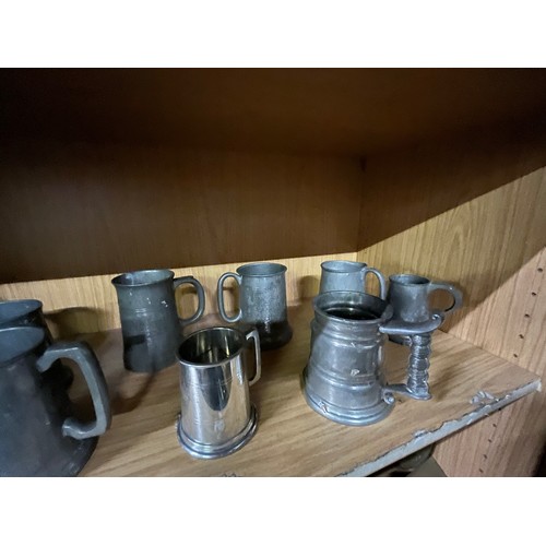 27 - 2 shelves of pewter tankards & brass wear