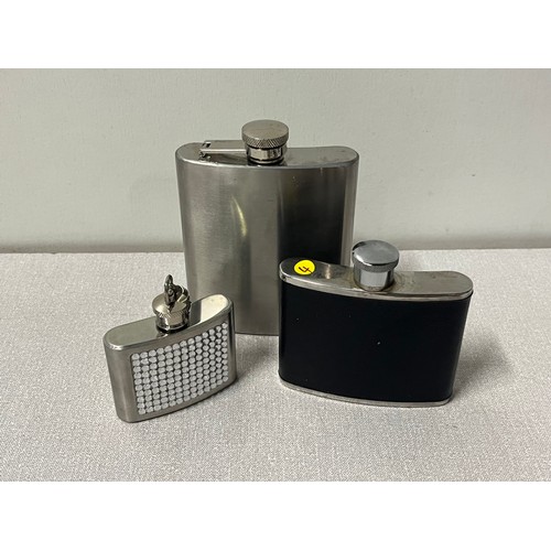 135 - 3 metal hip flasks.